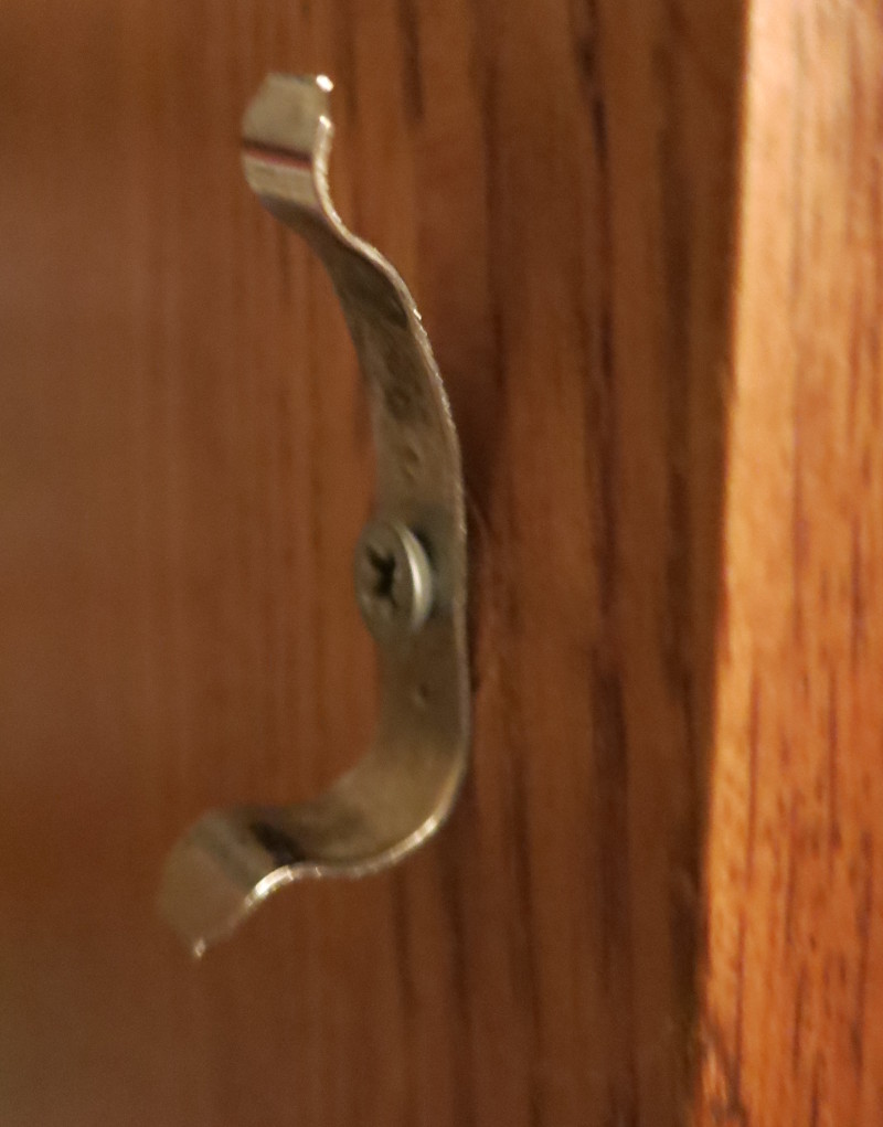 The failed metal clip, bent out of shape