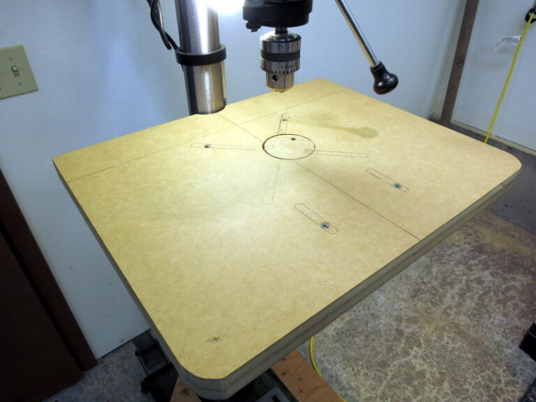 The table bolted to the drill press