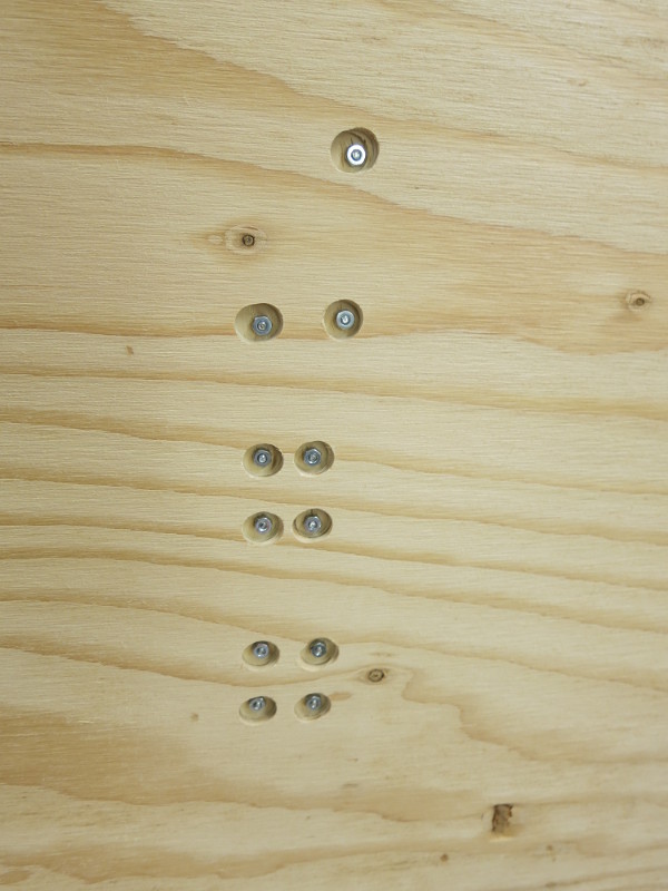 The back of the plywood base, showing the counterbored holes