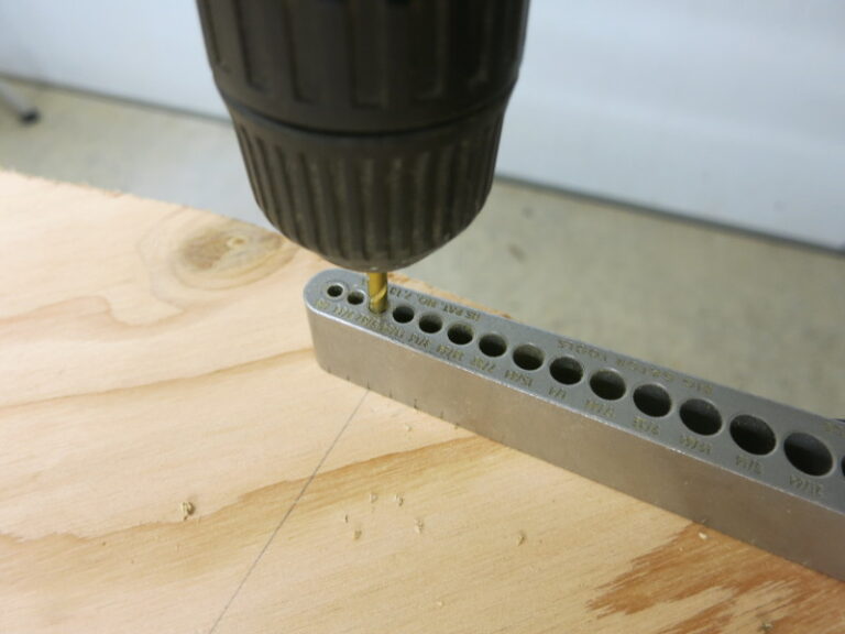 Drill one hole near the edge of the top plywood circle