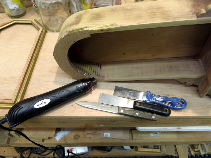 Tools for loosening a glued joint: a heat gun and putty knives.