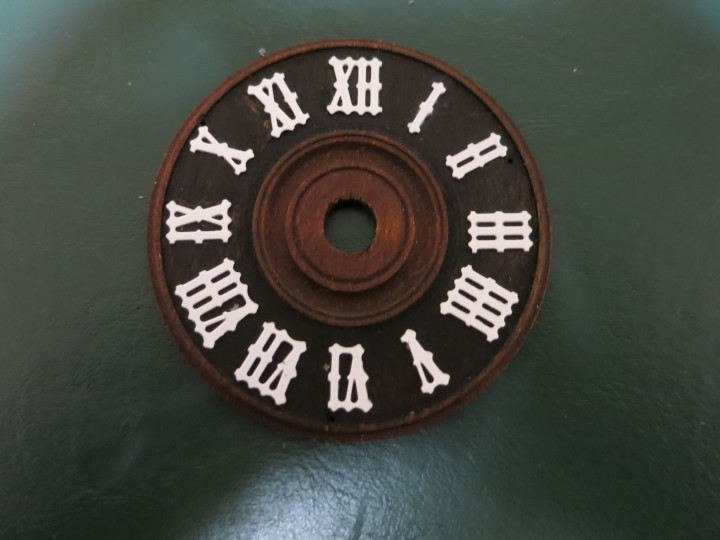 Cuckoo clock dial with new numerals glued on