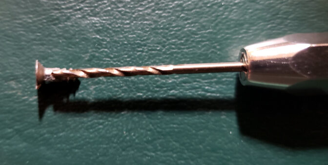 A hardened steel drill bit vs. a steel screw