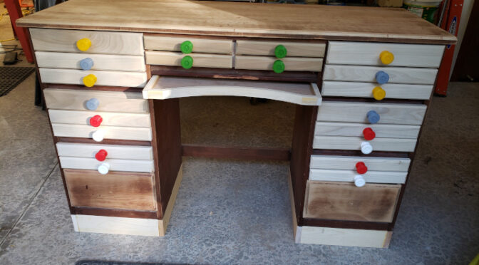 The unpainted drawers, with their drawer pulls on