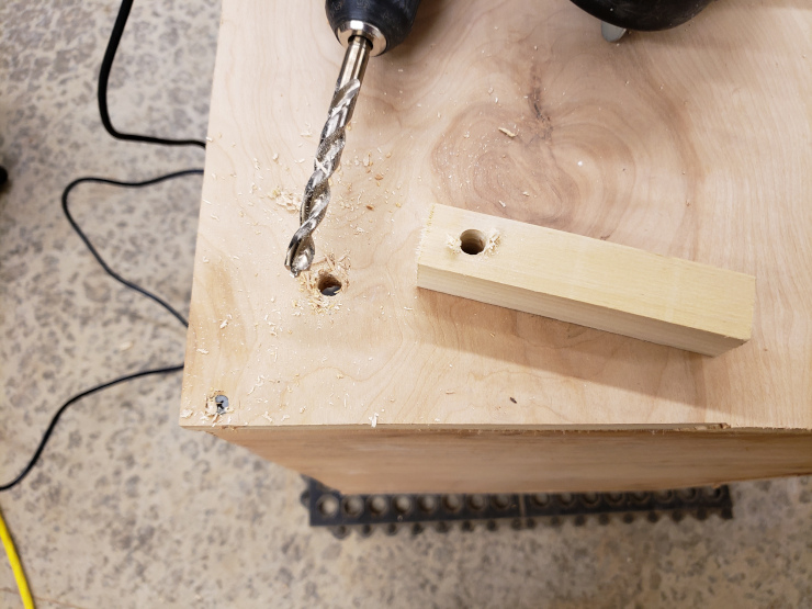 Drilling the final hole, with a temporary drill guide that I cut on a drill press